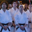 Miyagi-Do students standing with their hands crossed dressed in their karate uniforms for Cobra Kai | Agents of Fandom