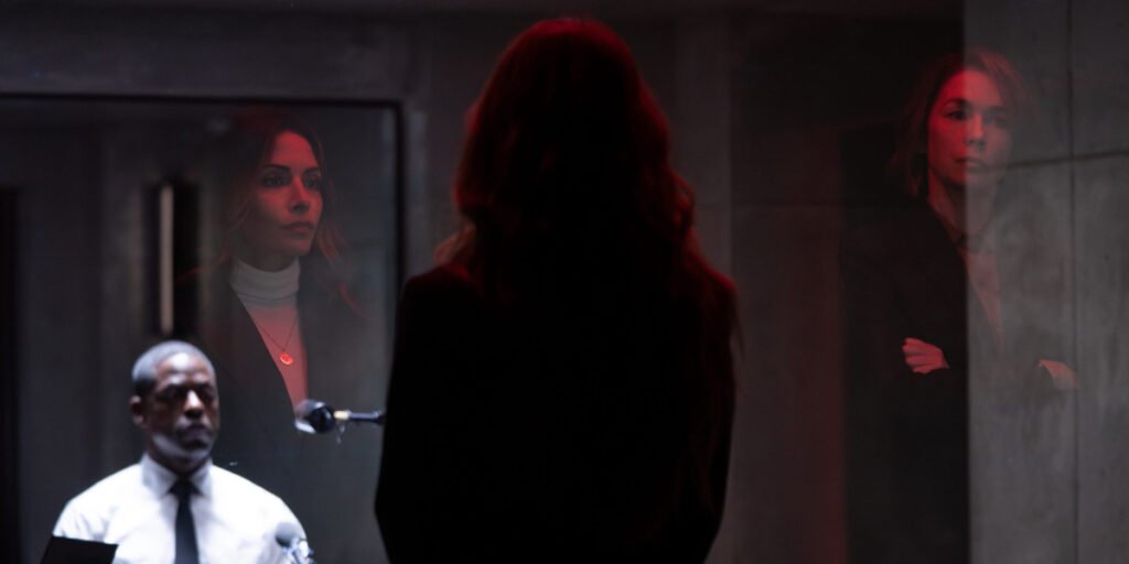 Xavier Collins (Sterling K. Brown) sitting in an interrogation room while Gabriela Torabi (Sarah Shahi) and Sinatra (Julianne Nicholson) watch through the glass in Paradise | Agents of Fandom