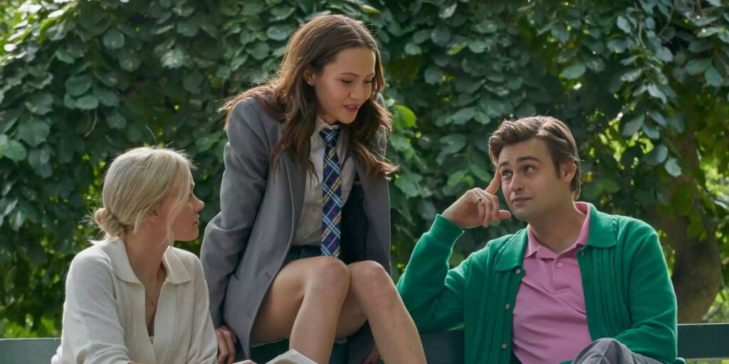 Charlotte (Alison Pill), Sissy (Iris Apatow), and Werther (Douglas Booth) sitting on a park bench in Young Werther | Agents of Fandom