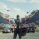 Captain America (Anthony Mackie) with his wings out in a park with cherry blossoms in Captain America: Brave New World | Agents of Fandom