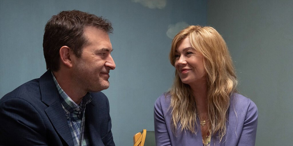 Kristine (Ellen Pompeo) and Michael Barnett (Mark Duplass) smile at each other in 'Good American Family.' | Agents of Fandom