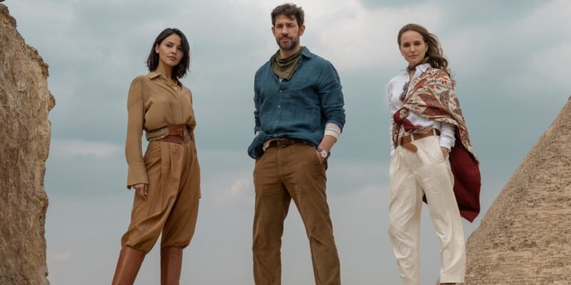 Eiza Gonzalez, John Krasinski, and Natalie portman posing by a pyramid for Fountain of Youth | Agents of Fandom
