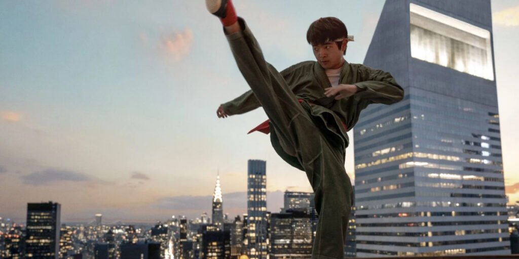 Li Fong (Ben Wang) doing a high kick on a New York rooftop in Karate Kid: Legends | Agents of Fandom