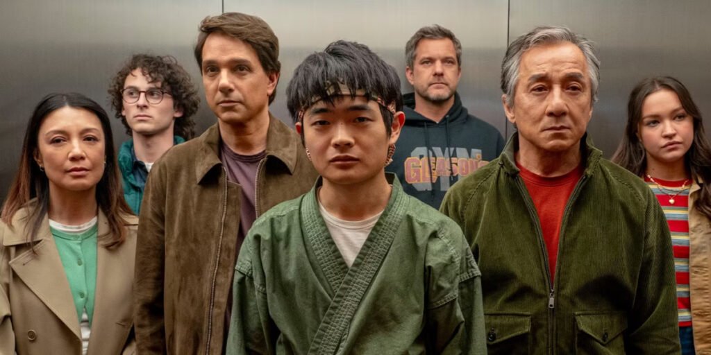 Dr. Fong (Ming-Na Wen), Alan (Wyatt Oleff), Daniel LaRusso (Ralph Macchio), Li Fong (Ben Wang), Victor Lipani (Joshua Jackson), Mr. Han (Jackie Chan), and Mia Lipani (Sadie Stanley) standing in an elevator in Karate Kid: Legends | Agents of Fandom
