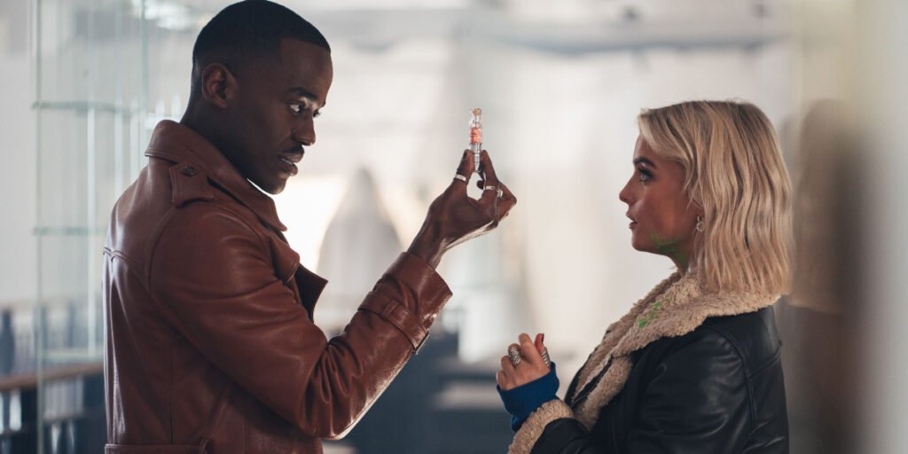 The Doctor holding an antidote with Ruby Sunday in front of him in Doctor Who Season 2 | Agents of Fandom