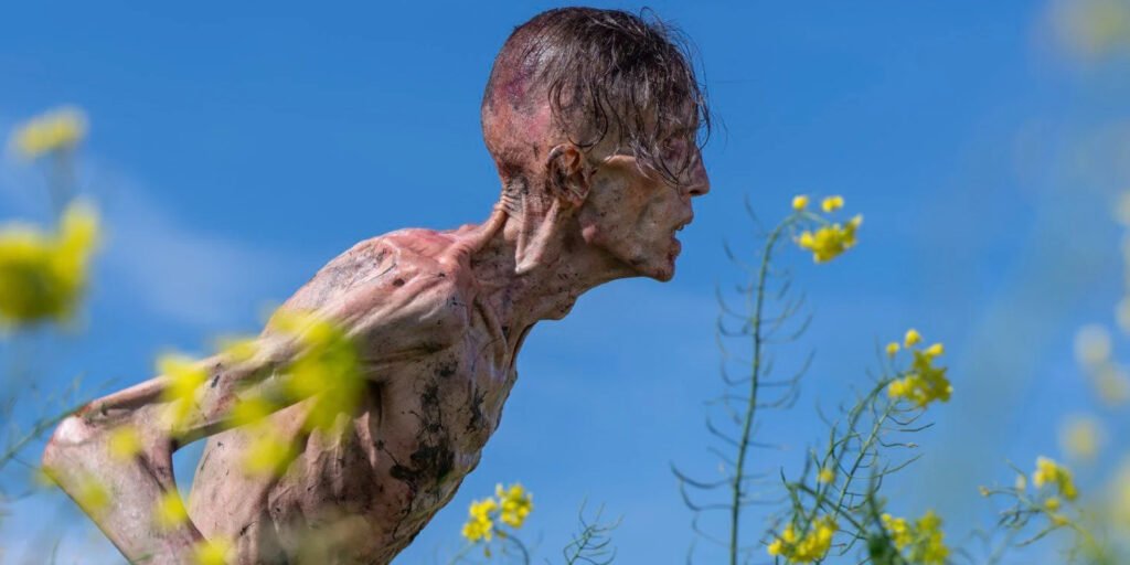 An infected walks through fields of flowers in 28 years Later | Agents of Fandom