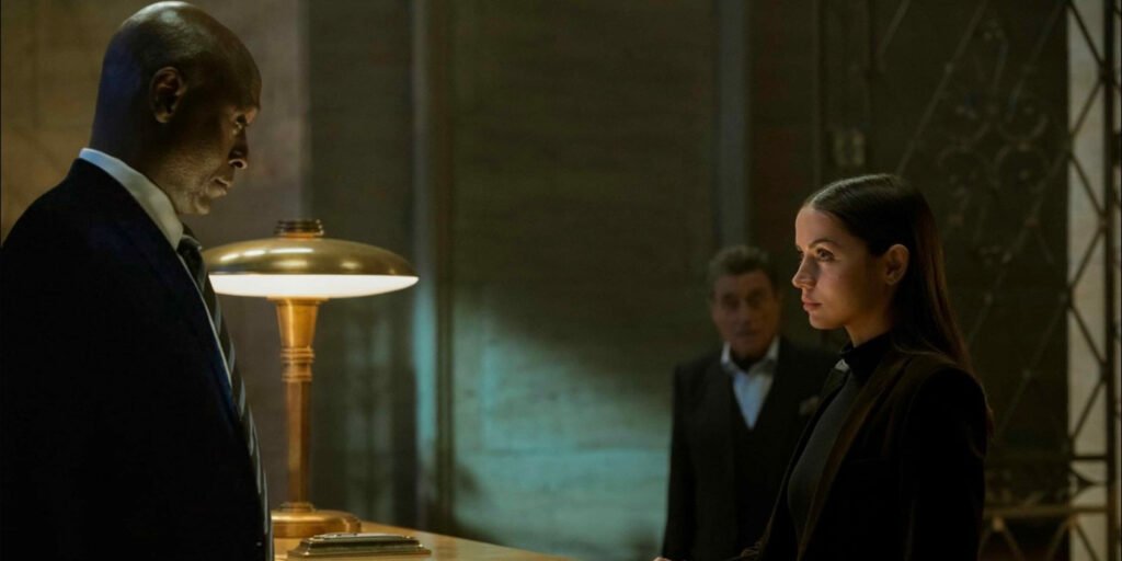 Charon, Eve, and Winston standing at the front desk of the Continental | Agents of Fandom