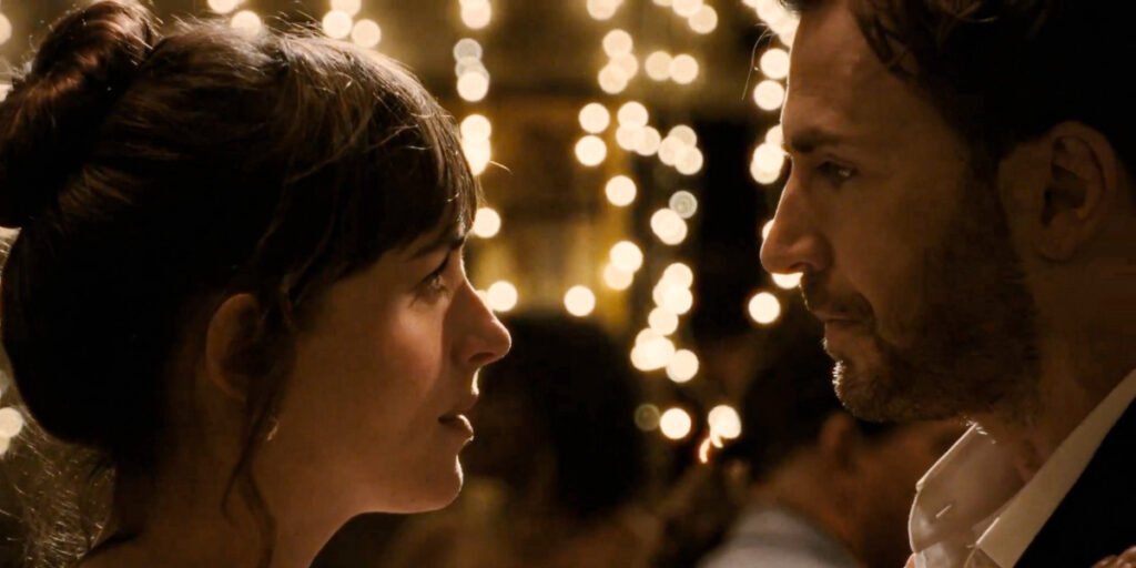 Lucy (Dakota Johnson) and John (Chris Evans) looking into each other's eyes in Materialists | Agents of Fandom