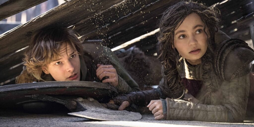 Mason Thames as Hiccup and Nico Parker as Astrid hide from a dragon in the How to Train Your Dragon live-action remake | Agents of Fandom
