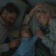 Reed Richards, Franklin Richards, and Sue Storm in bed in The Fantastic Four: First Steps | Agents of Fandom