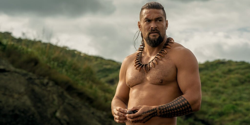 Jason Momoa standing shirtless in Chief of War | Agents of Fandom