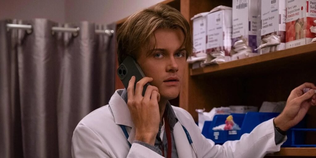 Conrad takes a phone call in a lab coat in The Summer I Turned Pretty Season 3 Episode 1 | Agents of Fandom
