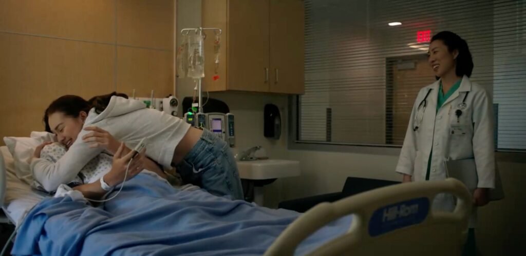 Belly embraces Steven on his hospital bed while Dr. Kwaan looks on | Agents of Fandm