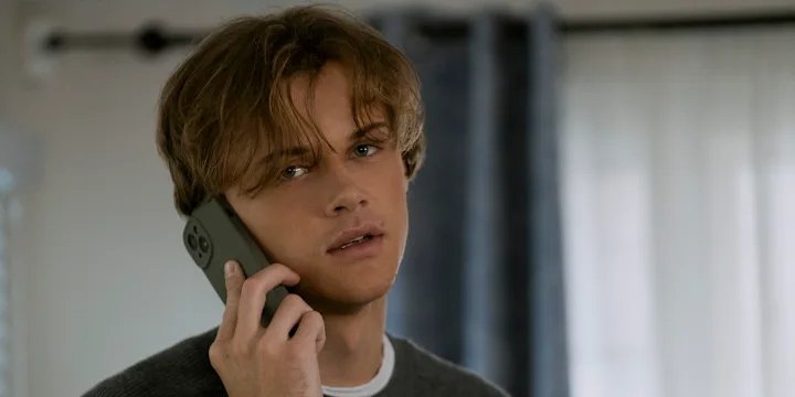 Conrad (Christopher Briney) talks on the phone. | Agents of Fandom.