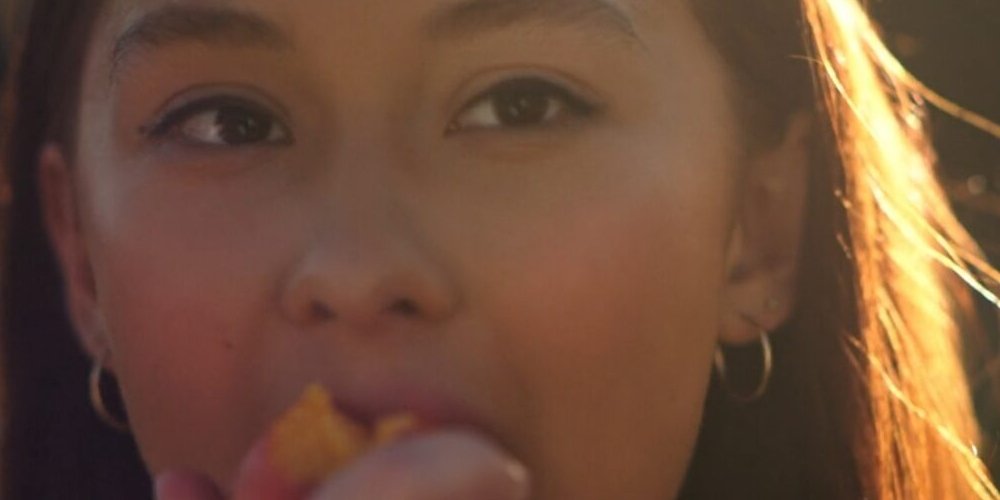 A close-up of Belly's eyes as she eats a peach in The Summer I Turned Pretty Season 3 Episode 5 | Agents of Fandom