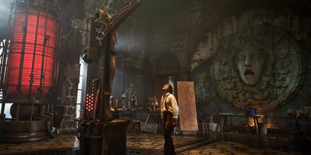 Victor Frankenstein (Oscar Isaac) staring up at his creation, The Creature (Jacob Elordi) in a giant lab in Guillermo del Toro's Frankenstein | Agents of Fandom