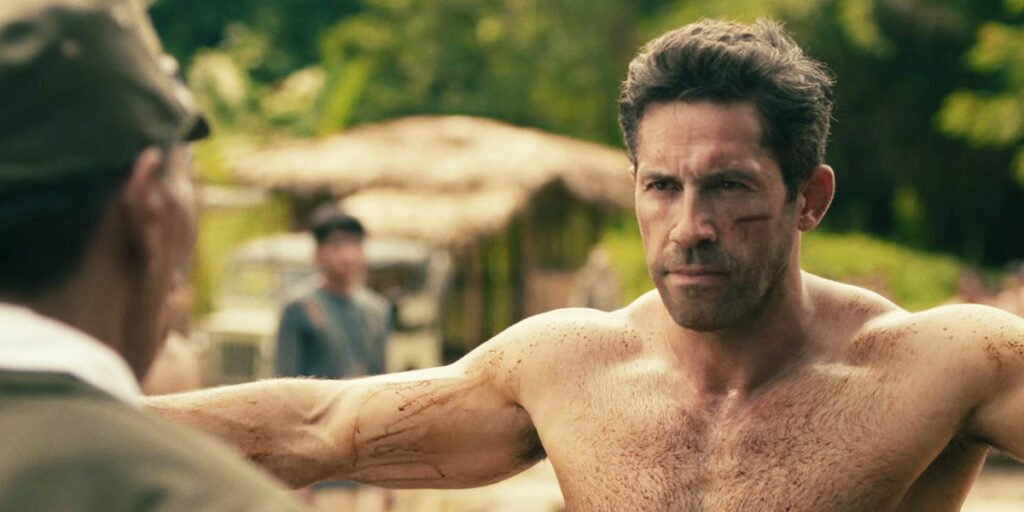 Scott Adkins shirtless and bloddied with his arms held out in Prisoner of War | Agents of Fandom
