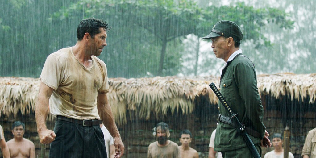 Scott Adkins squaring up with a general who carries a sword around his waist in Prisoner of War | Agents of Fandom