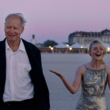 Gustav (Stellan Skarsgård, left) and Rachel Kemp (Elle Fanning, right) experience a magical meeting during an international film festival in Sentimental Value | Agents of Fandom