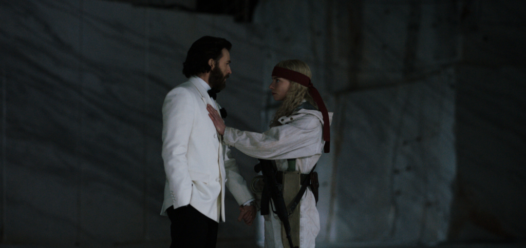 Anya Taylor-Joy holds her arm on Chris Evans' chest as they hold hands and stare into each others' eyes in 'Sacrifice' | Agents of Fandom