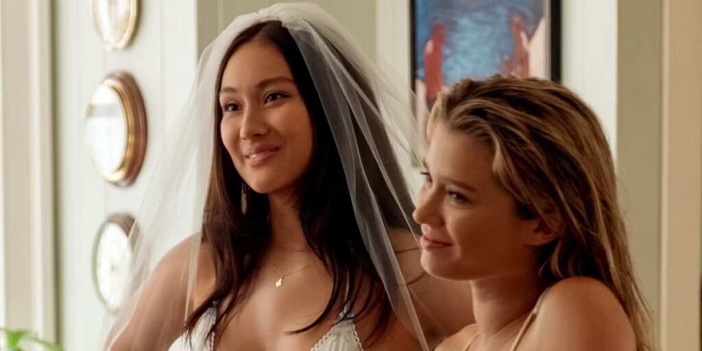 In The Summer I Turned Pretty Season 3 Episode 7, Belly looks up in her wedding dress while Taylor stands beside her | Agents of Fandom