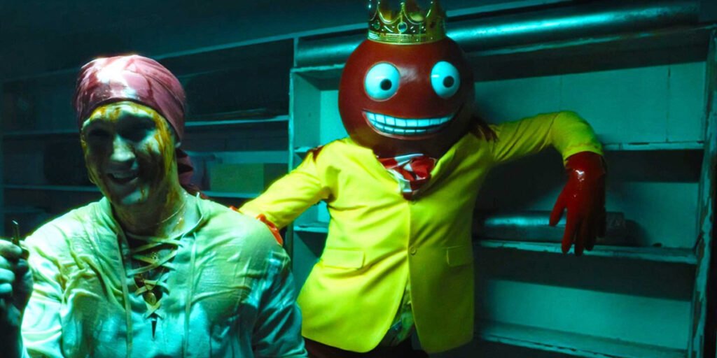 A man with a knife and a red masked king in “Fun Size” in ‘V/H/S/Halloween’ | Agents of Fandom