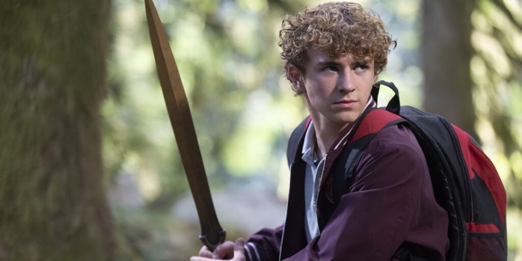 Percy draws his sword to protect Camp Half-Blood from Luke's forces in Percy Jackson and the Olympians Season 2 Episode 1 | Agents of Fandom