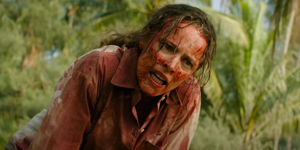 A very bloody Linda Liddle (Rachel McAdams) looks angry with a forest behind her in Send Help | Agents of Fandom