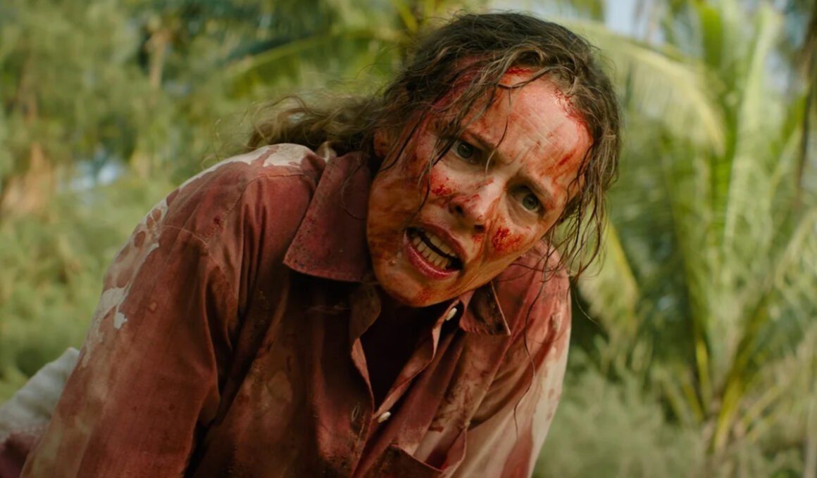 A very bloody Linda Liddle (Rachel McAdams) looks angry with a forest behind her in Send Help | Agents of Fandom