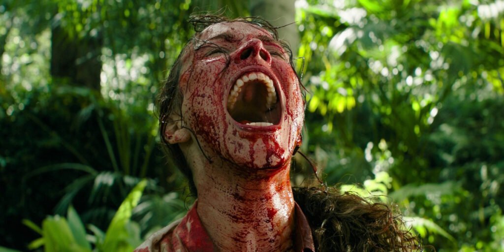 Linda Liddle (Rachel McAdams) covered in blood and screaming passionately while in a jungle in Send Help | Agents of Fandom