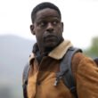 Xavier Collins (Sterling K. Brown) staring off into the distance while carrying a bag of gear in Paradise Season 2 | Agents of Fandom