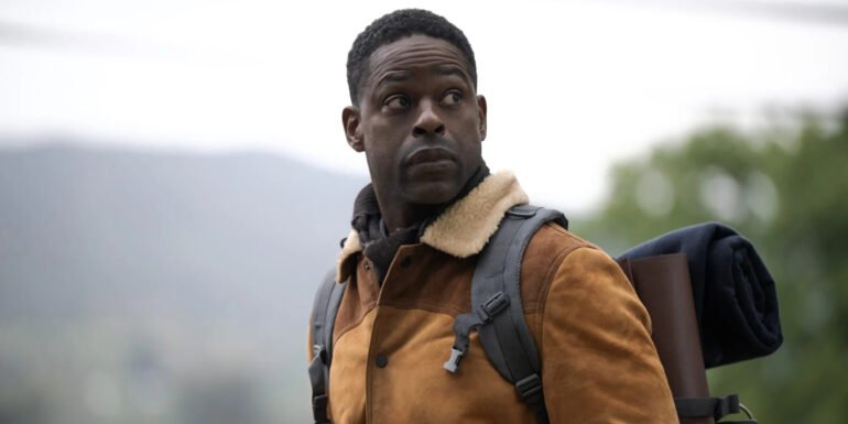 Xavier Collins (Sterling K. Brown) staring off into the distance while carrying a bag of gear in Paradise Season 2 | Agents of Fandom