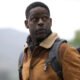 Xavier Collins (Sterling K. Brown) staring off into the distance while carrying a bag of gear in Paradise Season 2 | Agents of Fandom
