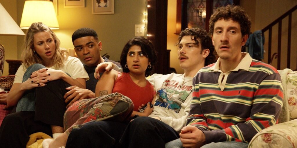 Billie, Anton, Issa, Paul Baker, and Samir cuddle up on the couch in Adults | Agents of Fandom